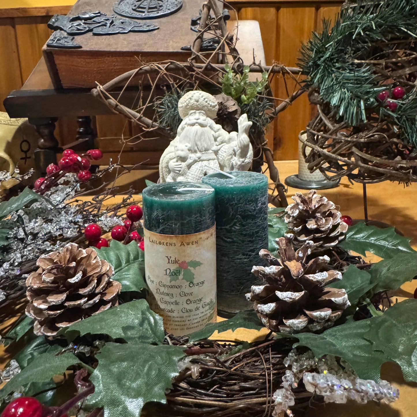 handcrafted dark green scented spell candle made with pine, cinnamon, orange, nutmeg and clove, and used for yule rituals, winter solstice rituals, and for celebrating the rebirth of the sun, and the light of the sun on the increase